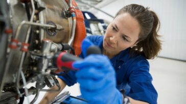 stock photo female helicopter mechanic repairing part 2142552985 transformed
