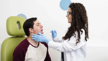 side view doctor examining patient throat min scaled 1