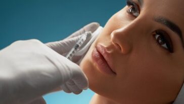 cosmetologist using syringe correct female face 651396 838