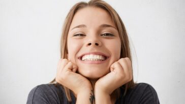 close up indoor portrait happy excited young female celebrating success promotion work looking with broad cheerful smile holding hands her face feeling joy happiness 273609 7409