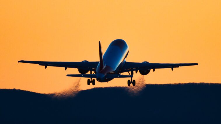 rear view silhouette of an airplane taking off at royalty free image 1695239529 4