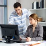 front distanced view young beautiful lady grey shirt talking discussing something with young man inside office daytime building job activity 1 1 1 optimized 250