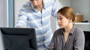 front distanced view young beautiful lady grey shirt talking discussing something with young man inside office daytime building job activity 1 1 1 optimized 250