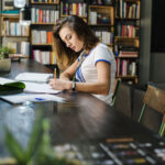 Mastering Self-Publishing: Your Ultimate Step-by-Step Guide 20 girl sitting table with notebooks writing 1 optimized 2000