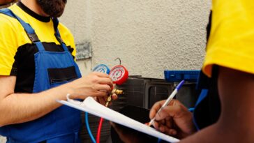coworkers refill air conditioner freon 1