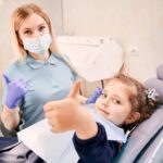 female dentist cute little girl giving thumbs up 651396 2220