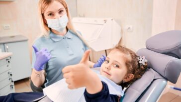 female dentist cute little girl giving thumbs up 651396 2220