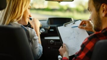 instructor helps woman to drive the car e1627375431416 paq4v6p5zyi2kr2t796hwy7odreta7xv9us74ptt00