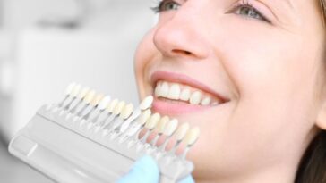 young woman dentist office checking selecting colour teeth 392895 188525