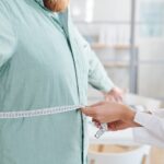 Bariatric Surgery Cost Analysis Supporting Better Life Balance 21 closeup doctor measuring waist overweight man his visit hospital 249974 9993